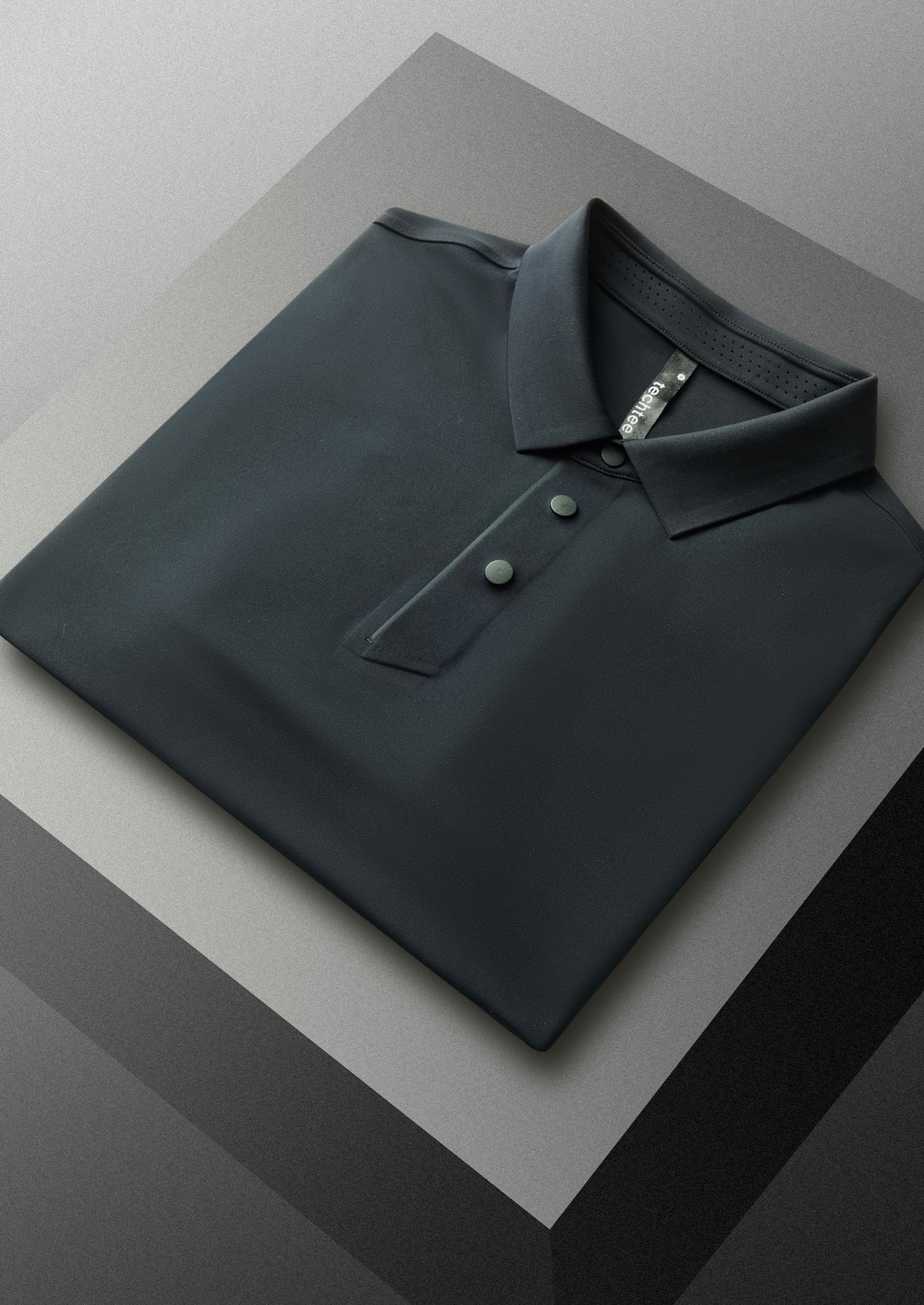 Black polo shirt on a reflective surface