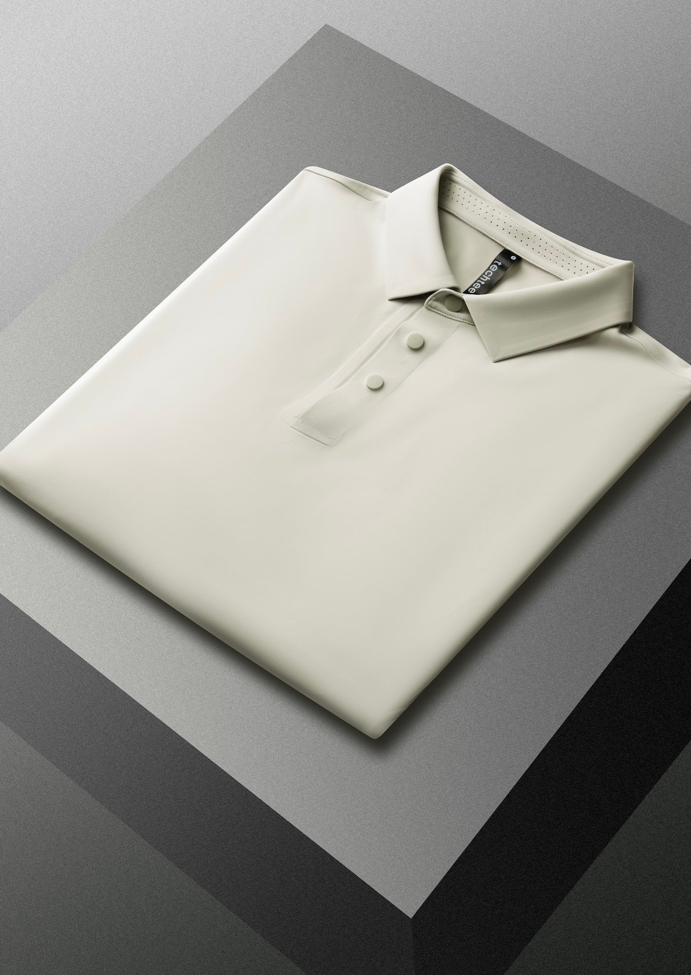 Grey polo shirt on a reflective surface