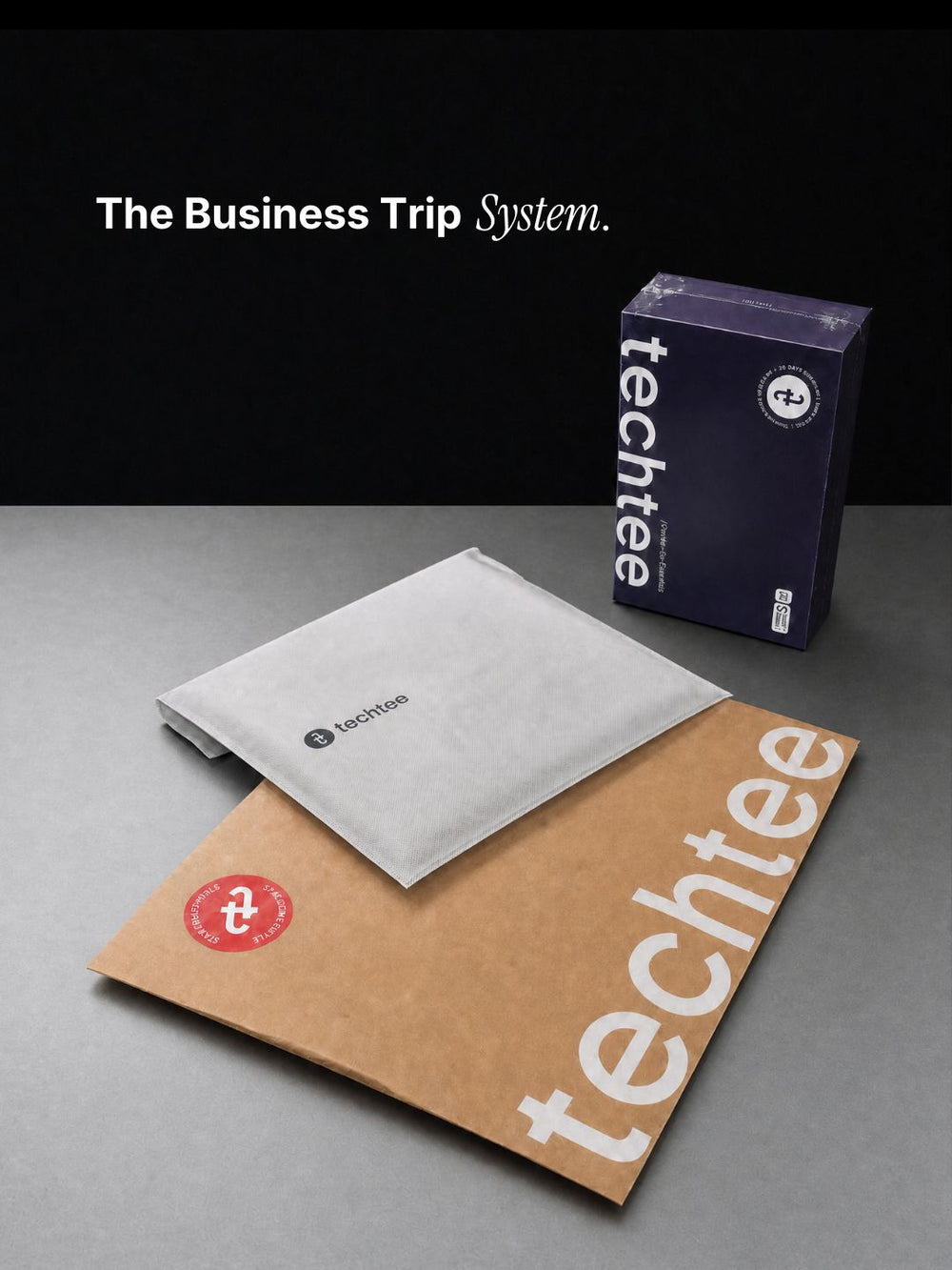 techtee branded items including a box, non-woven pouch, and packaging bag on a gray surface.