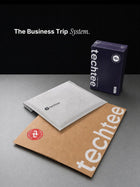 techtee branded items including a box, non-woven pouch, and packaging bag on a gray surface.