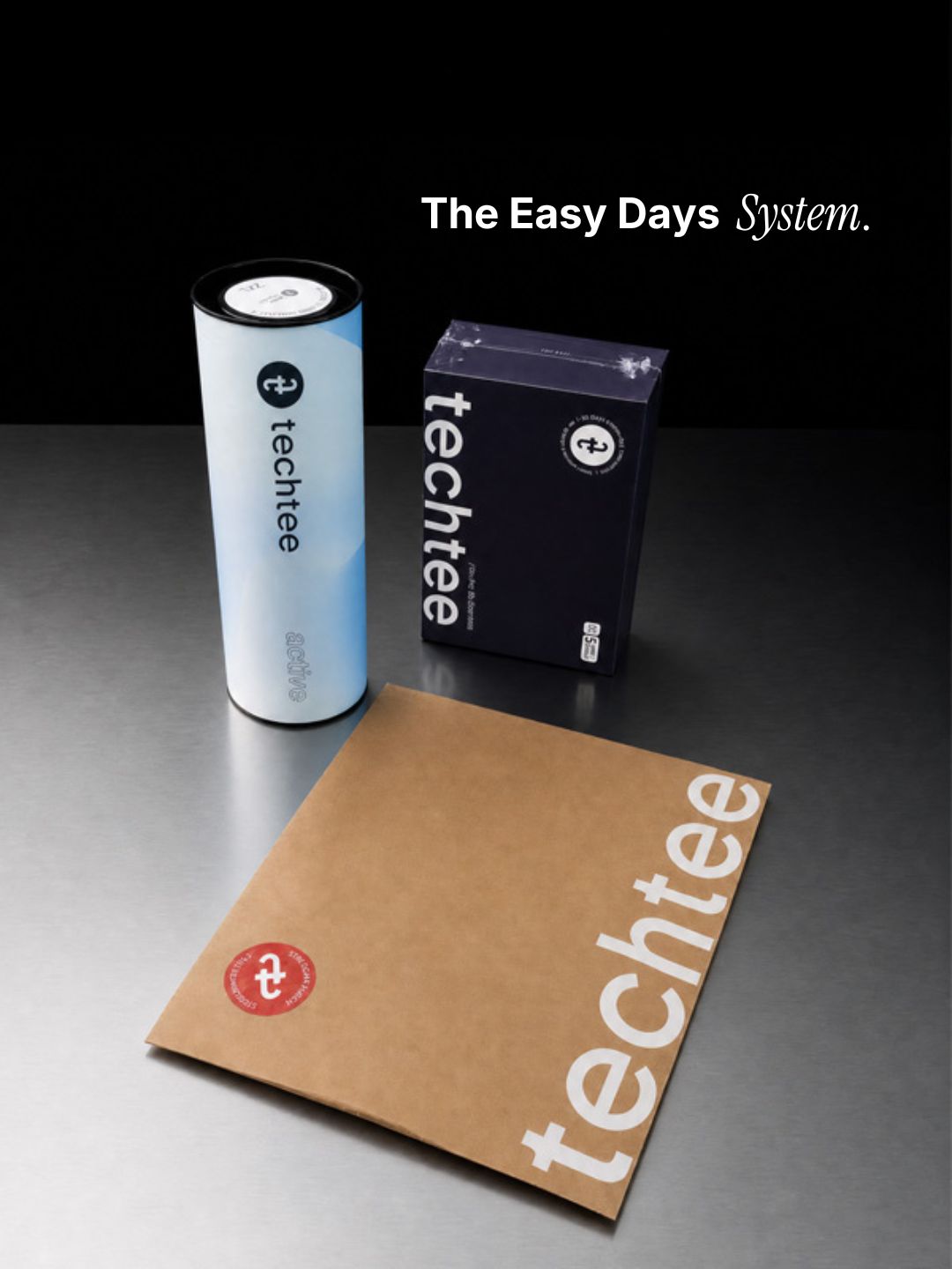 techtee products including a cylindrical container, a box, and a brown paper bag on a dark surface.