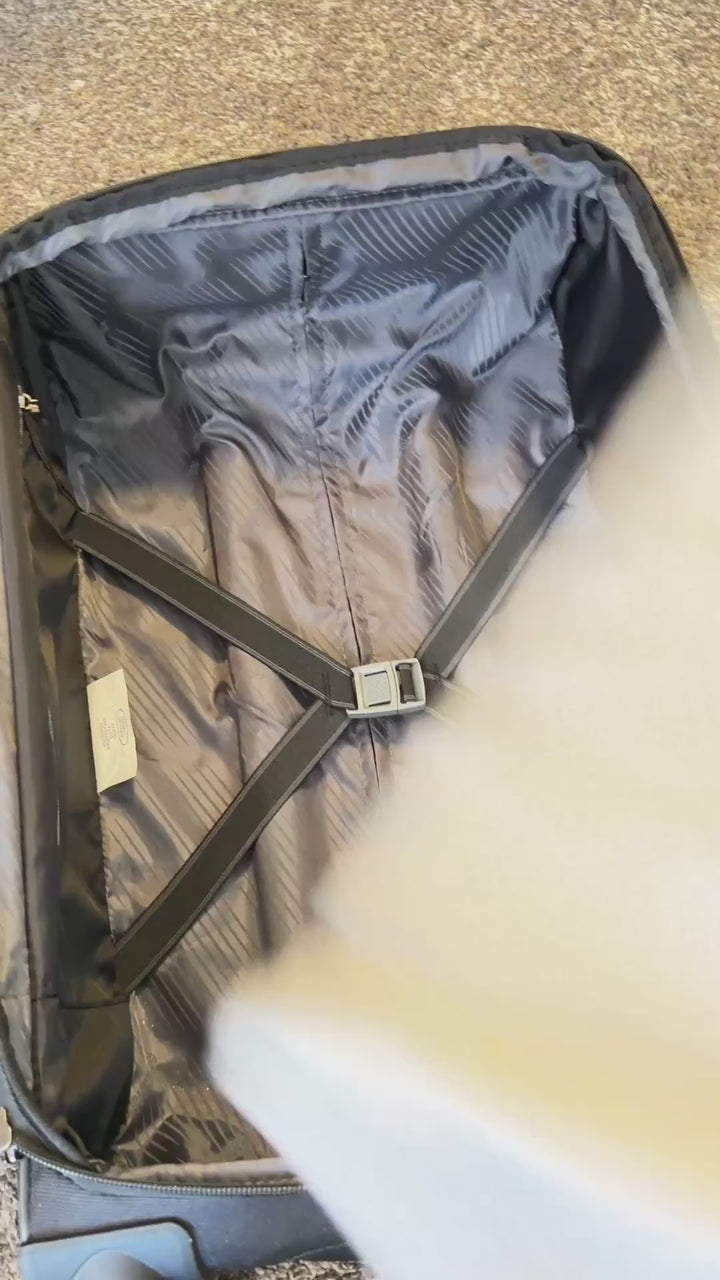 Man packing TechTee travel set into a carry-on luggage, space-saving performance apparel for business travel