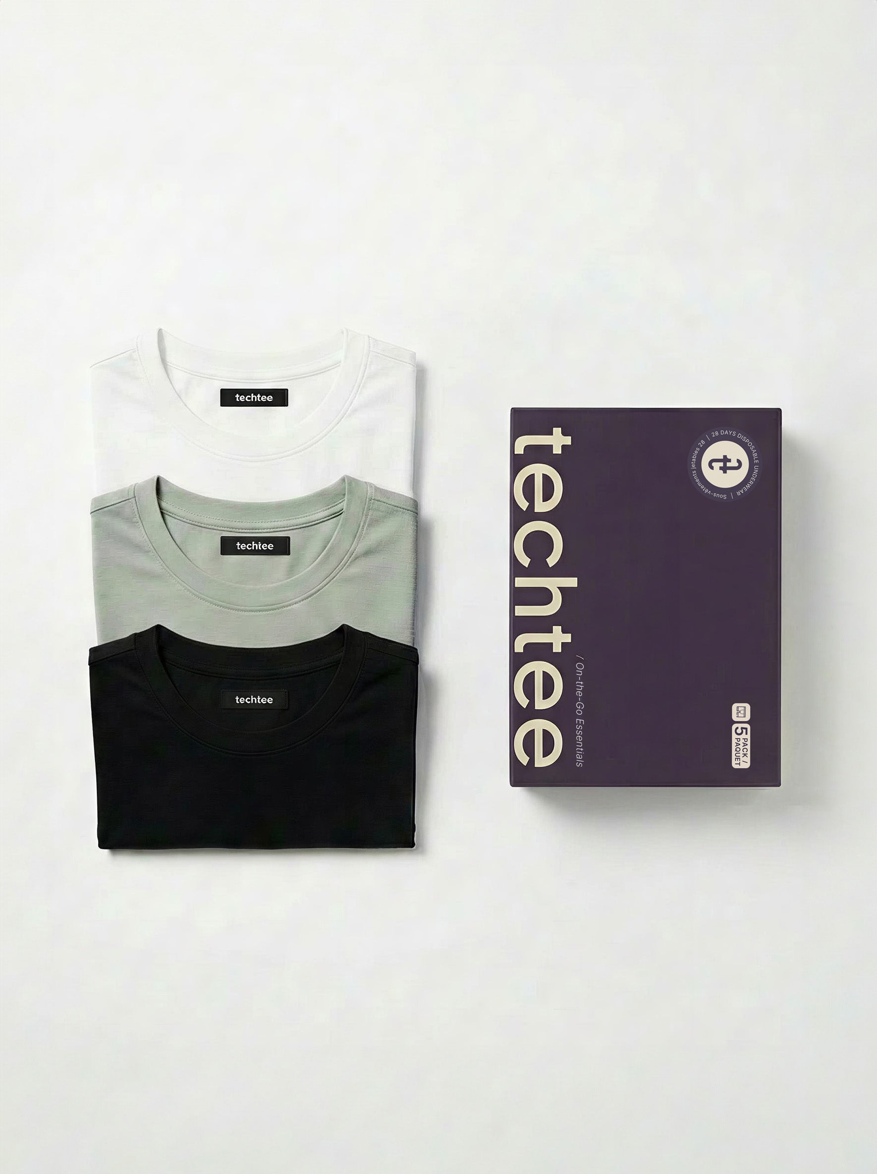 Three folded t-shirts in black, gray, and white with a 'techtee' box on a white background.