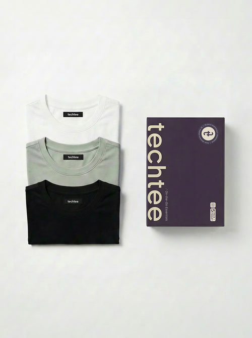 Three folded t-shirts in black, gray, and white with a 'techtee' box on a white background.